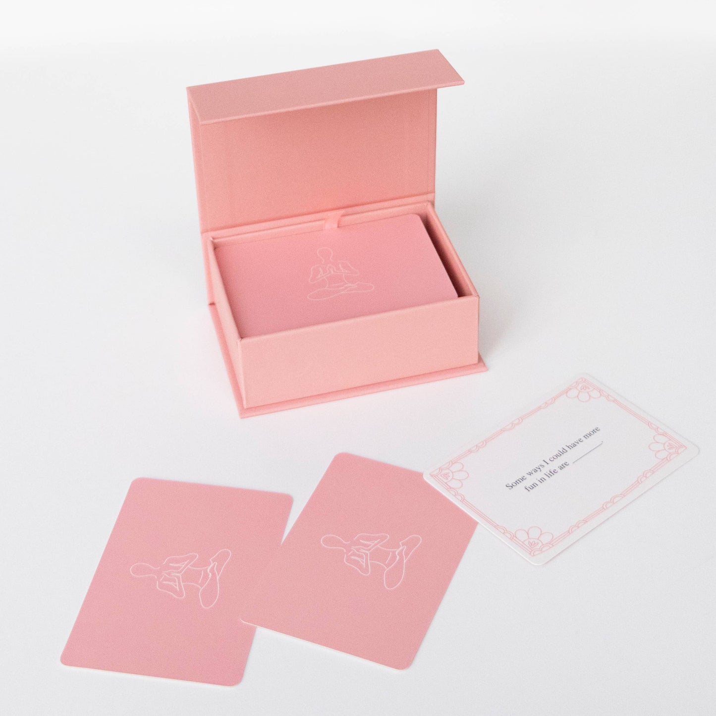 Pink card deck box with two pink cards on a white background