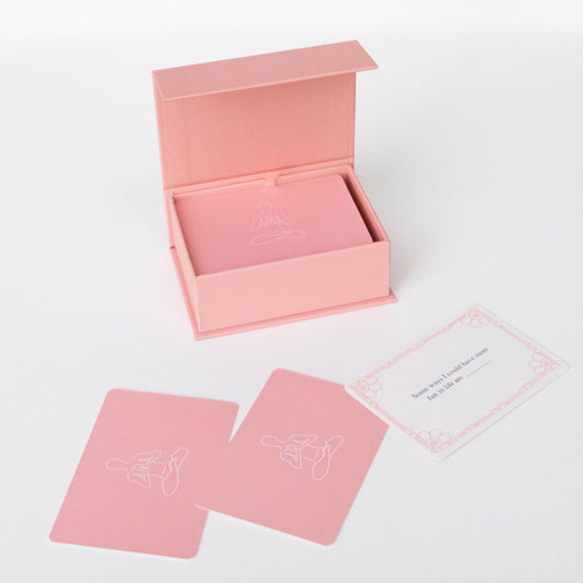Pink card deck box with two pink cards on a white background