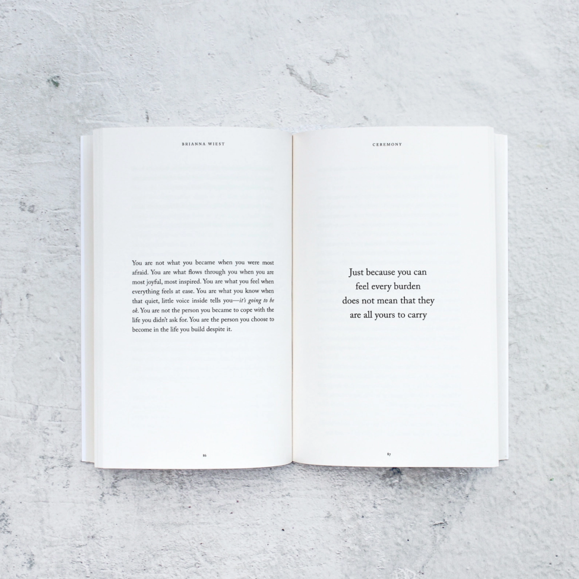 Open book with text on a textured gray surface