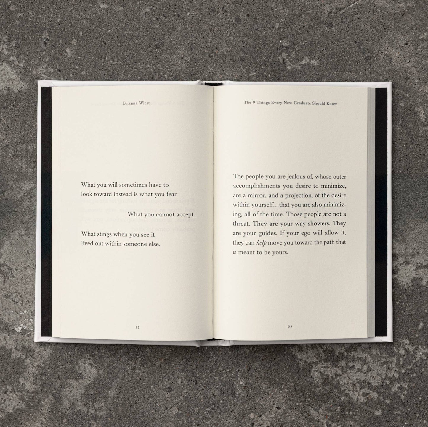 Open book with text on a textured gray surface