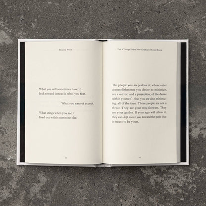 Open book with text on a textured gray surface