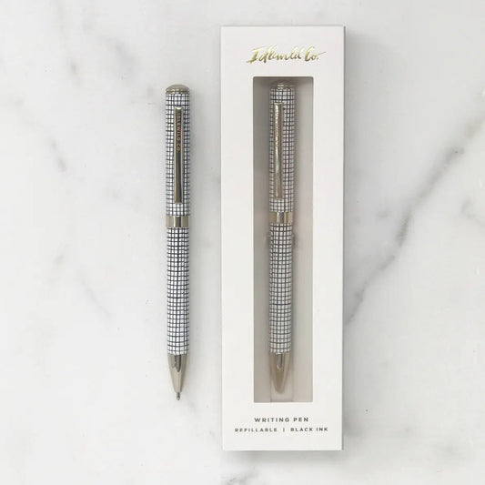 Pen with checkered design in a white box on a marble background
