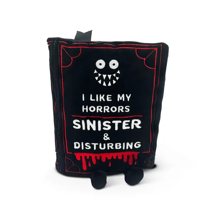 Black plush with a monster face and text on a white background