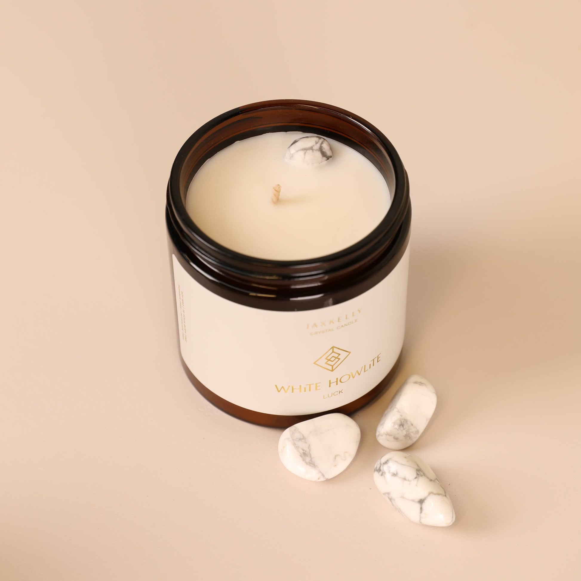 Candle in a glass jar with a wooden lid on a beige background