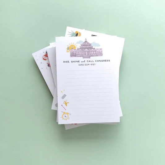 Stack of notepads with illustrated notepads on a light green background